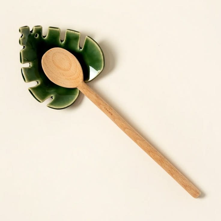 Green ceramic monstera leaf spoon rest with wooden spoon